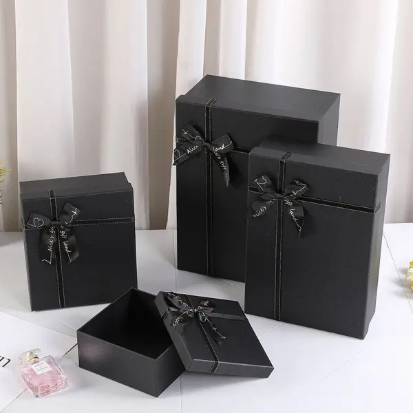 Black cardboard boxes stacked for premium packaging and shipping